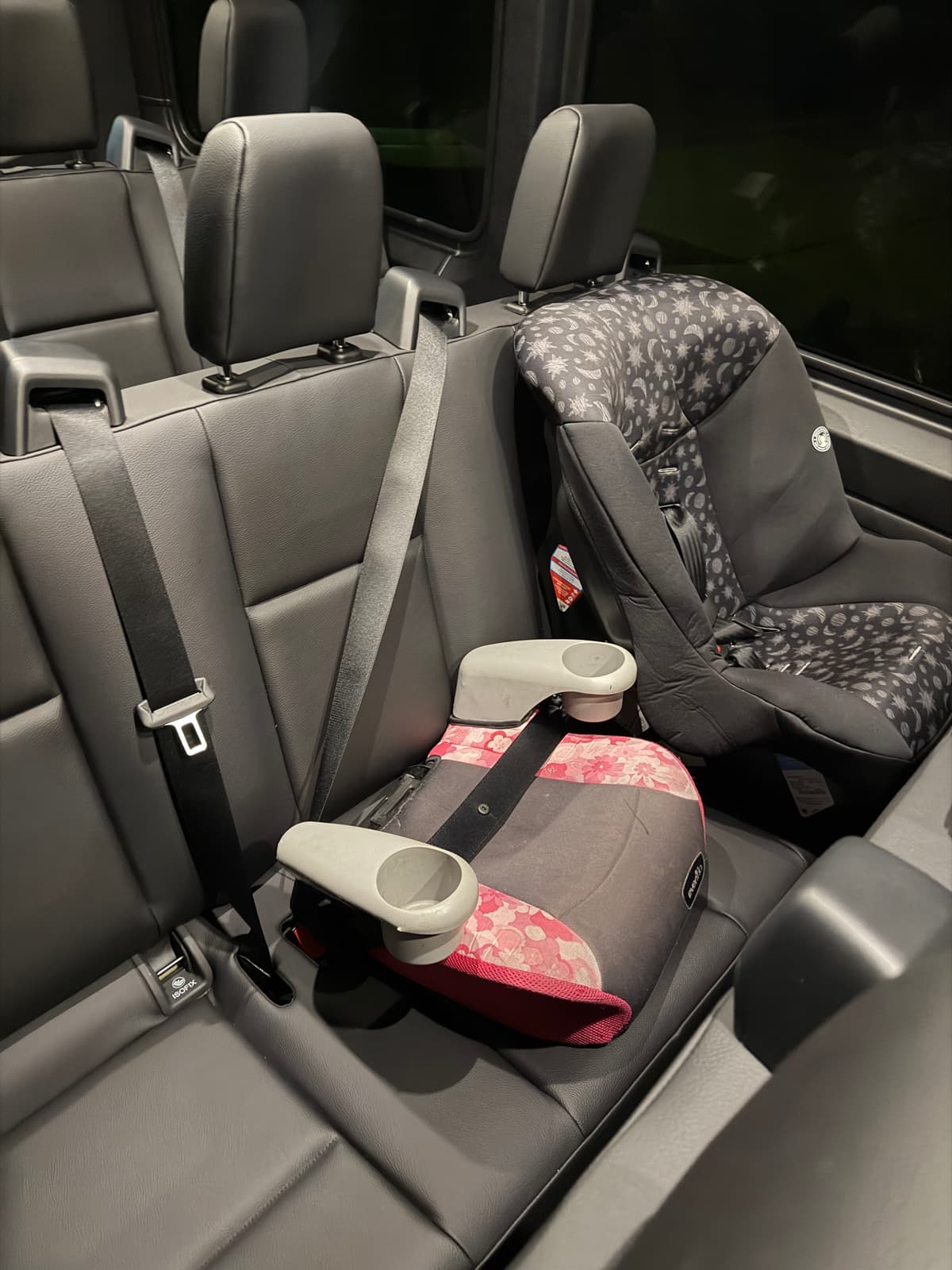 Booster seat with car seat in vehicle for family Disney transfers